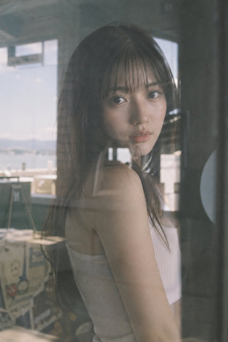 Japanese negative film aesthetic, reflective surface scene, soft natural light, slight overexposure highlights, low contrast, muted tones, subtle grain a beautiful japanese idol seen thro...