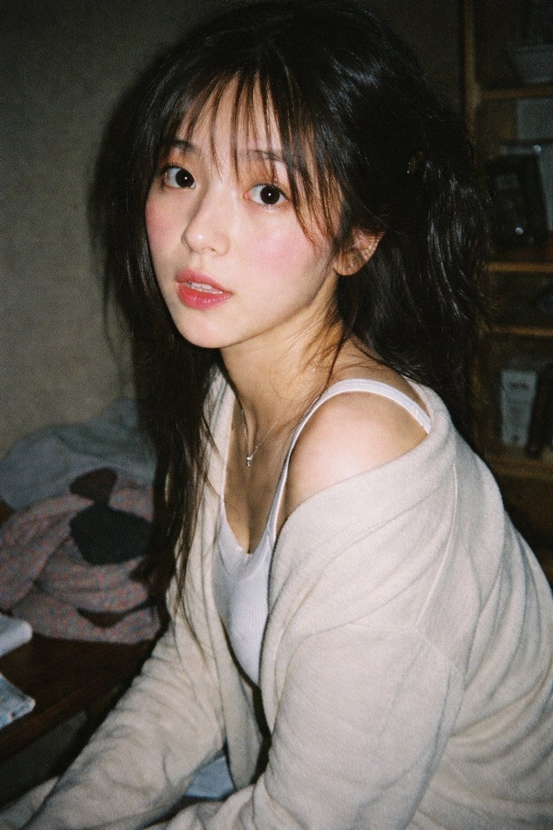 Generates a highly realistic, candid portrait with a vintage film aesthetic and direct flash lighting.