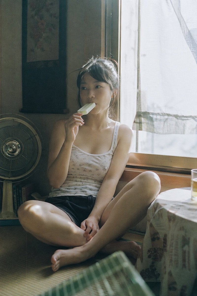 Japanese negative film aesthetic, quiet summer afternoon, natural candid moment, soft sunlight through window, slight overexposure highlights, low contrast but rich tonal layers, muted an...