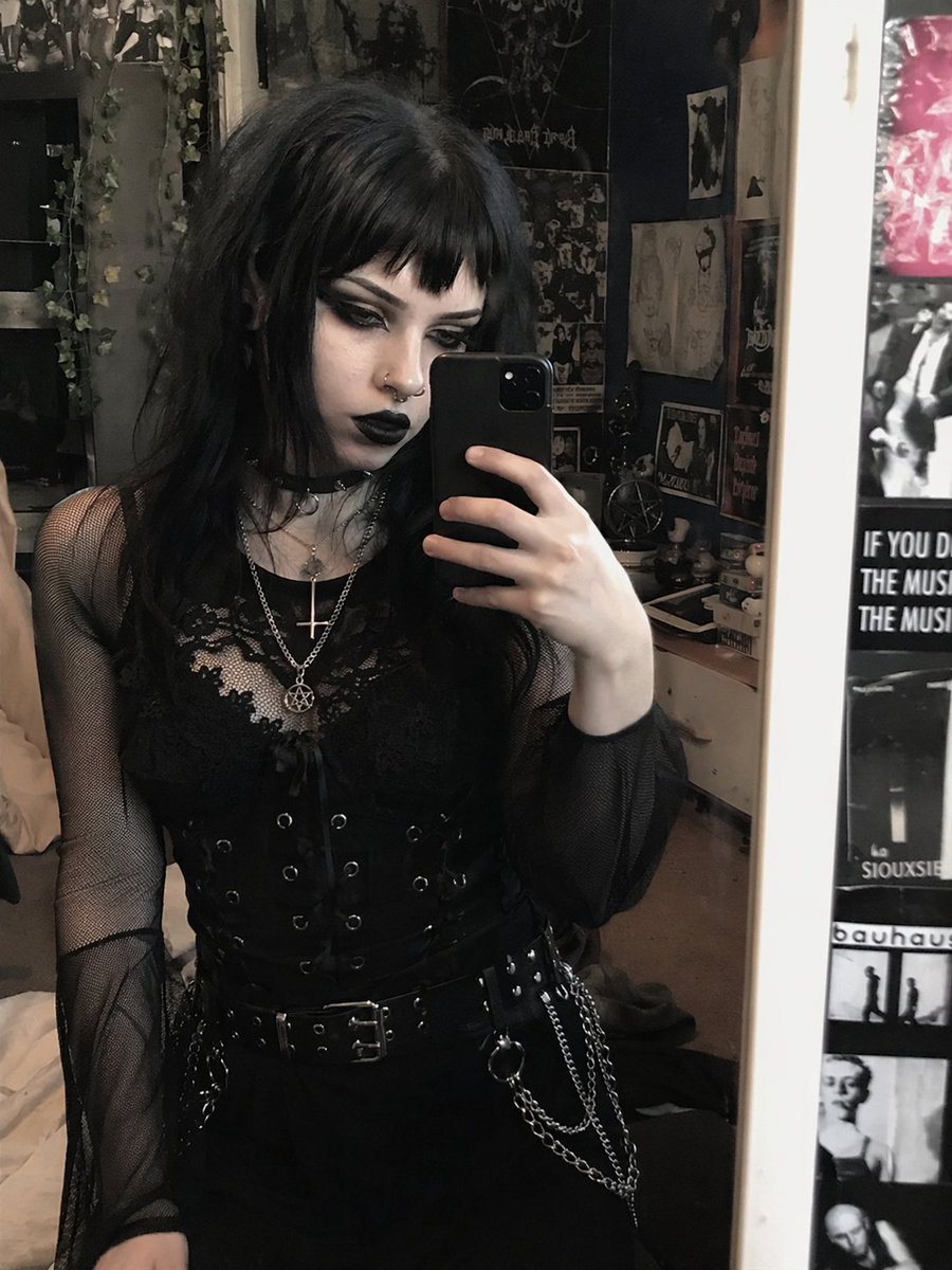 Transforms a reference portrait into a heavy goth aesthetic by altering hair, makeup, and jewelry while preserving the original pose and outfit.