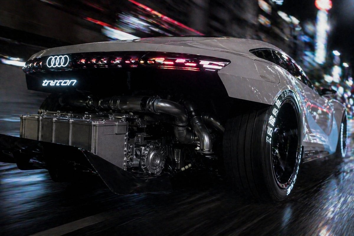 A cinematic rear three-quarter tracking shot of a futuristic white Audi supercar racing through a dense neon-lit city at night on a wet street, viewed from a very low angle close to the r...