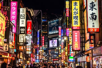 A photorealistic night street photography shot of a bustling Tokyo street, heavily illuminated by densely packed vertical neon signs and billboards. On the left, a bright pink sign promin...